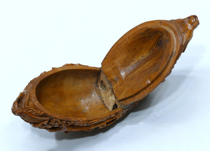 Opened coquilla nut snuff box showing the interior